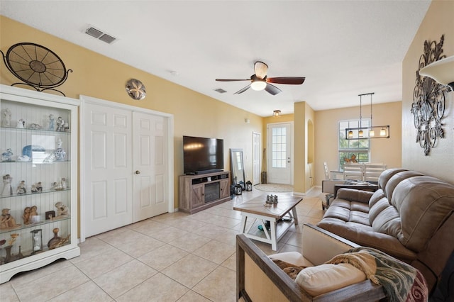 living room featuring ceiling fan and light tile patterned floors