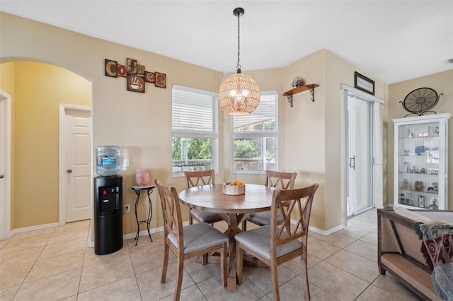 dining room with light tile patterned flooring and a notable chandelier