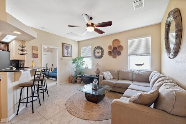 living room with ceiling fan and light tile patterned flooring