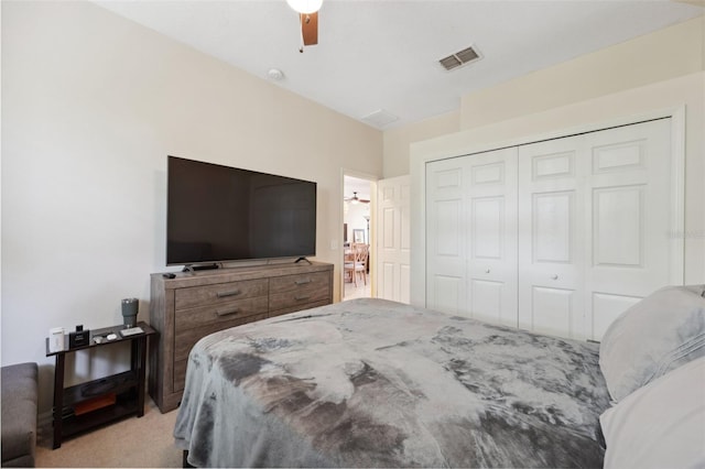 bedroom with a closet, ceiling fan, and light colored carpet