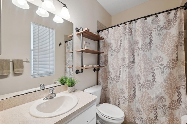 bathroom featuring toilet and vanity