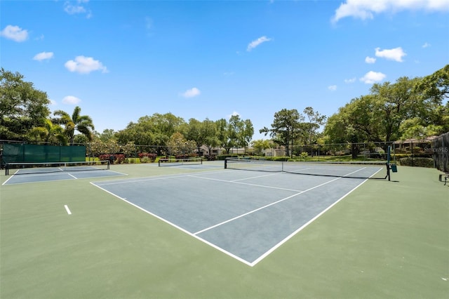 view of tennis court featuring basketball hoop