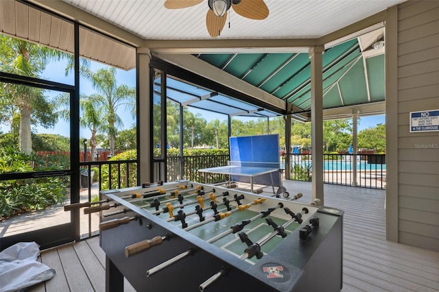 sunroom featuring vaulted ceiling and ceiling fan