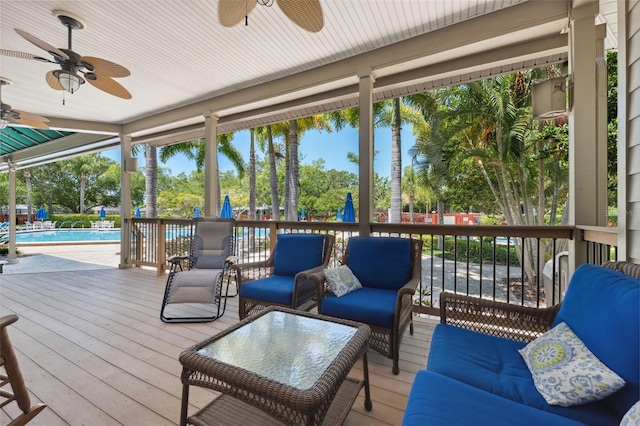 wooden deck with ceiling fan and an outdoor hangout area