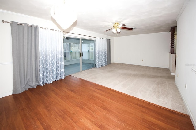 carpeted empty room with ceiling fan and crown molding