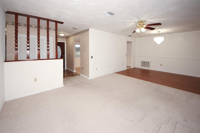 unfurnished living room with ceiling fan and carpet