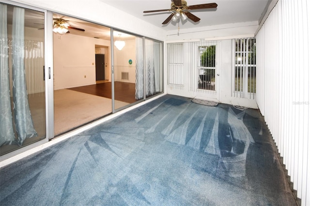 unfurnished sunroom featuring ceiling fan