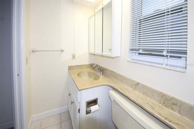 bathroom featuring tile patterned floors, vanity, and toilet