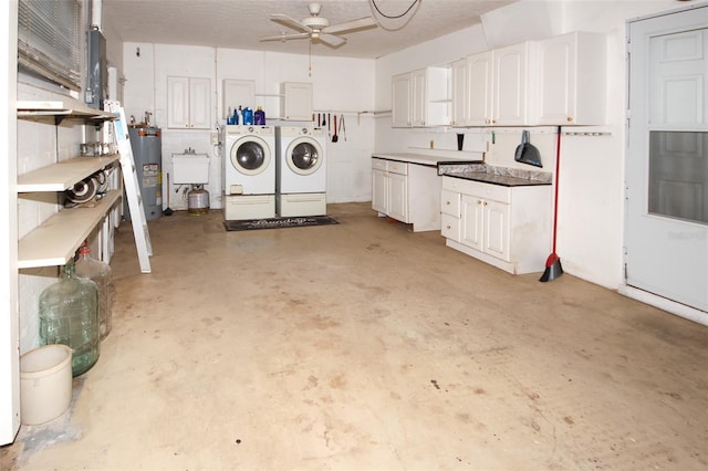 interior space with a textured ceiling, electric water heater, ceiling fan, sink, and washer and dryer