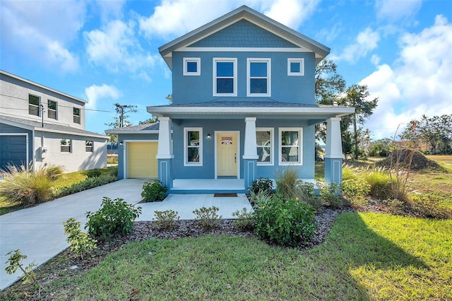 view of front facade with a front yard, a porch, and a garage