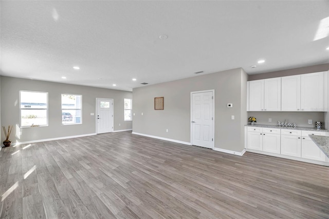 unfurnished living room with light wood-type flooring