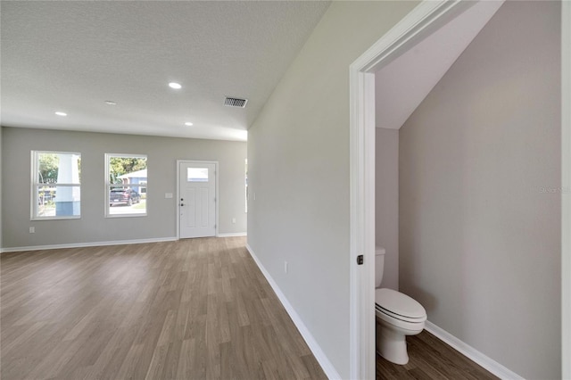 entrance foyer featuring light hardwood / wood-style floors and a textured ceiling