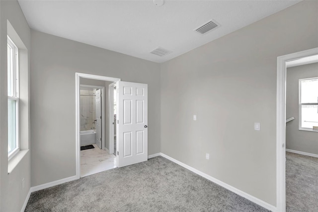 unfurnished bedroom featuring light colored carpet