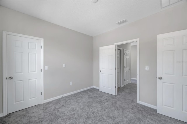 unfurnished bedroom featuring light carpet