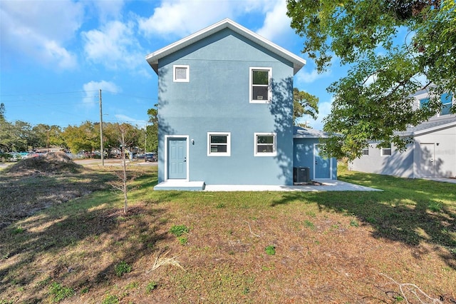 rear view of property with a yard and central AC unit