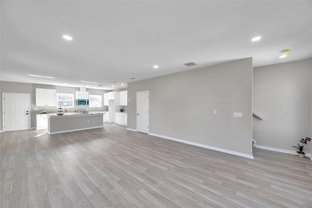 unfurnished living room with light hardwood / wood-style flooring