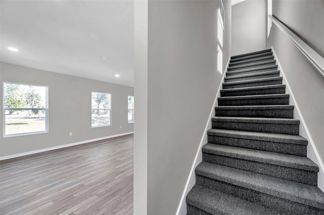 stairway with hardwood / wood-style floors