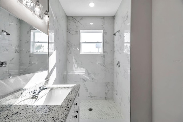 bathroom featuring vanity and tiled shower