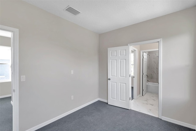 unfurnished bedroom with dark carpet