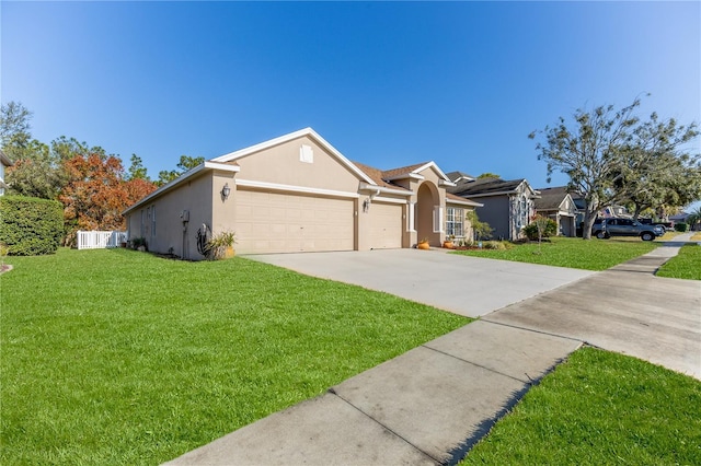 ranch-style home featuring a front lawn and a garage