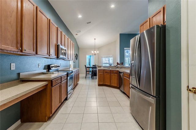 kitchen with appliances with stainless steel finishes, a notable chandelier, decorative light fixtures, vaulted ceiling, and sink