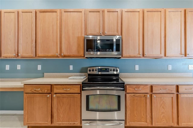 kitchen with appliances with stainless steel finishes and light brown cabinetry