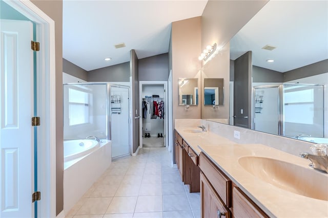 bathroom with tile patterned flooring, vanity, vaulted ceiling, and independent shower and bath