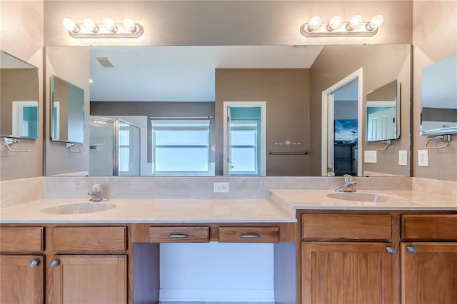 bathroom featuring walk in shower and vanity