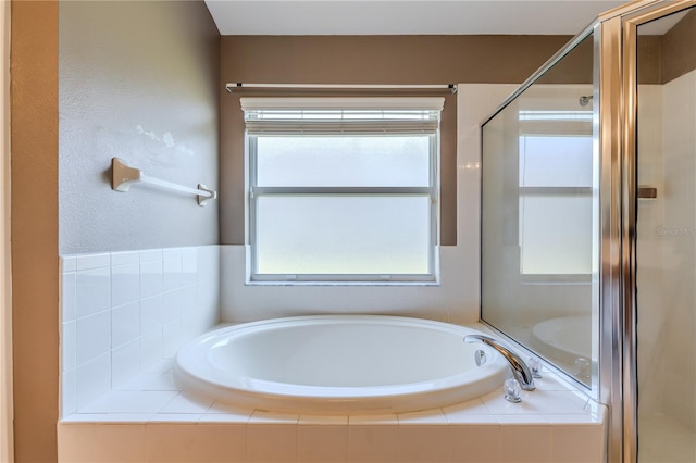 bathroom featuring shower with separate bathtub