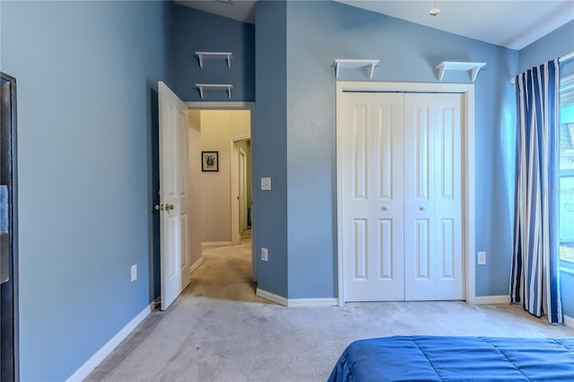 carpeted bedroom featuring vaulted ceiling, a closet, and multiple windows