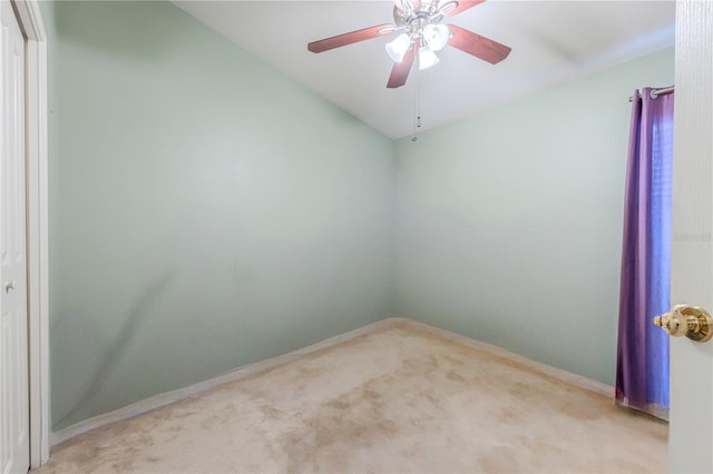 empty room featuring ceiling fan and light colored carpet