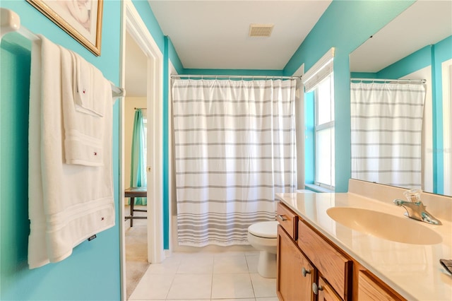 bathroom with toilet, tile patterned floors, and vanity