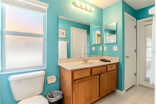 bathroom featuring toilet, tile patterned flooring, and vanity