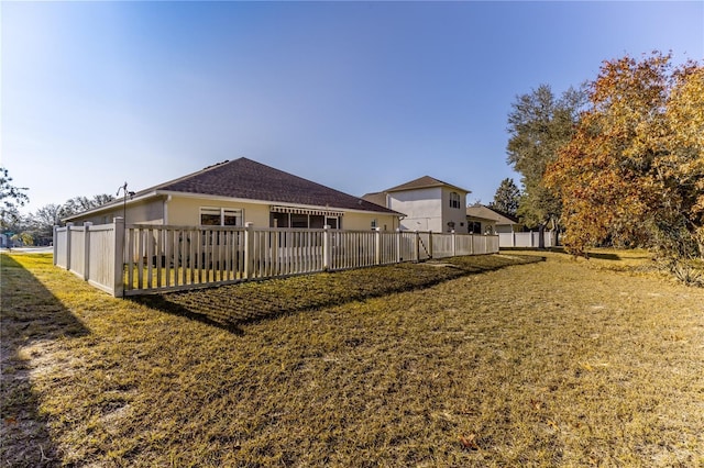 back of property featuring a lawn