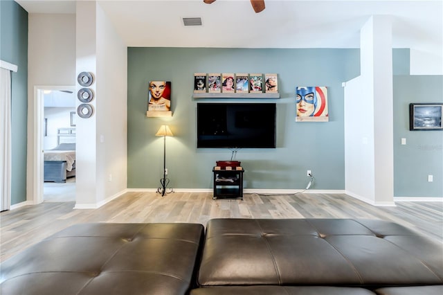 living room with hardwood / wood-style flooring and ceiling fan