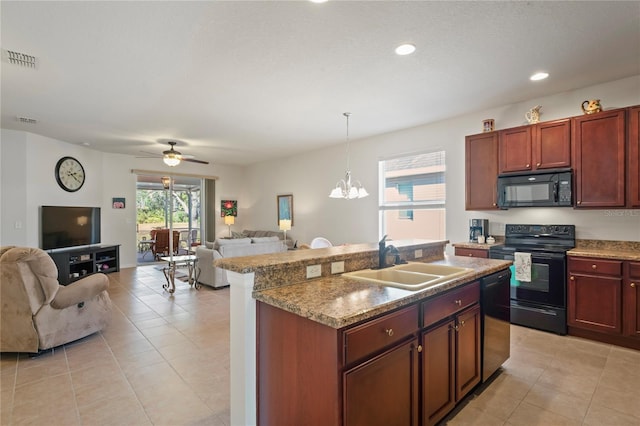 kitchen with pendant lighting, black appliances, a center island with sink, sink, and ceiling fan with notable chandelier