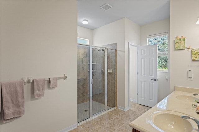 bathroom with tile patterned flooring, an enclosed shower, and vanity