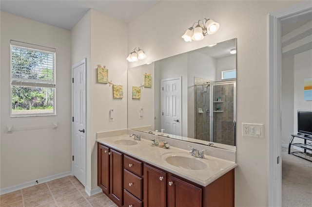 bathroom with tile patterned floors, an enclosed shower, and vanity