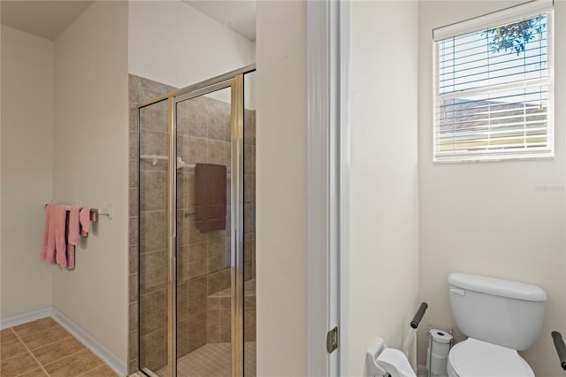 bathroom with a shower with shower door and toilet