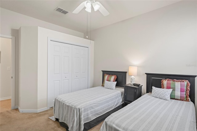 carpeted bedroom with ceiling fan and a closet