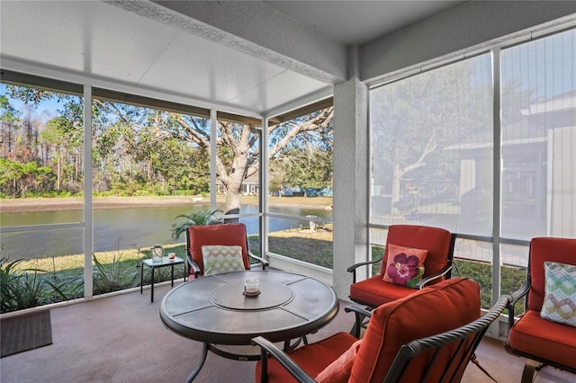 sunroom / solarium with a water view and a healthy amount of sunlight