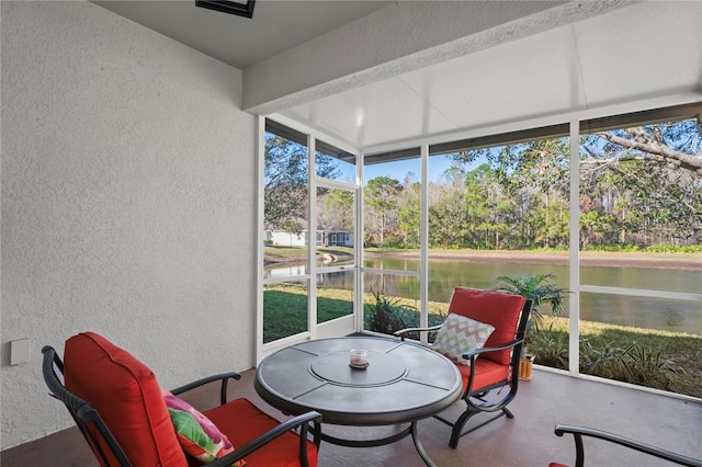 sunroom / solarium with a water view