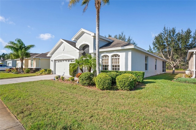 view of front of property featuring a front lawn and a garage