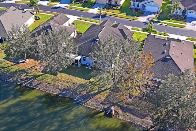 birds eye view of property with a water view