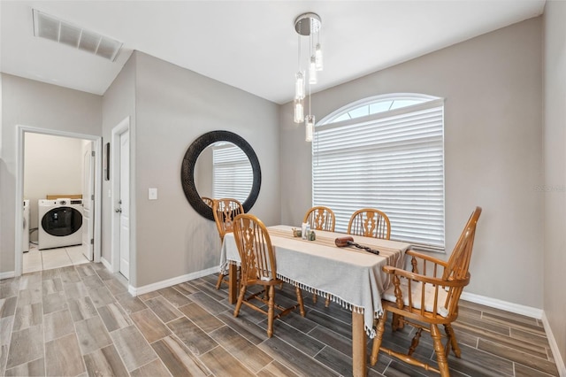 dining area featuring washing machine and dryer and hardwood / wood-style flooring