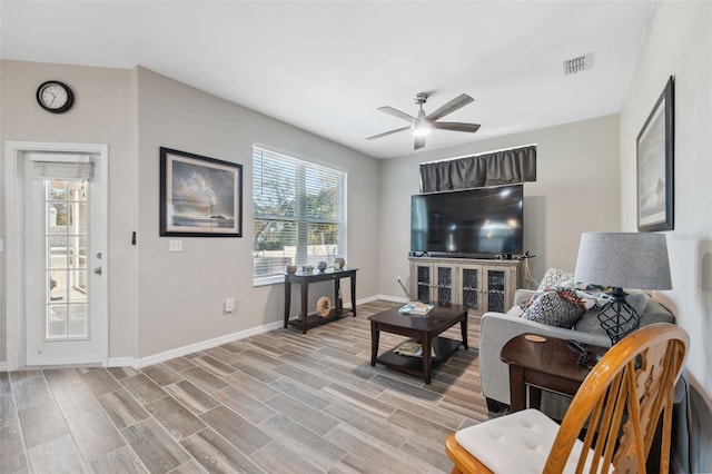 living room featuring ceiling fan and light hardwood / wood-style flooring