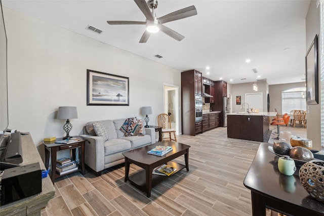 living room featuring sink and ceiling fan