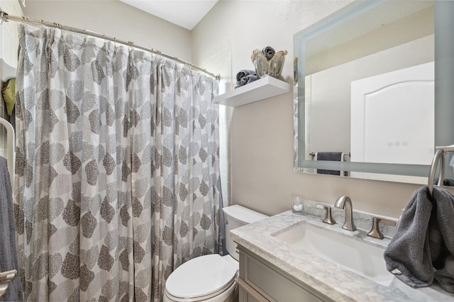 bathroom featuring toilet, vanity, and a shower with curtain