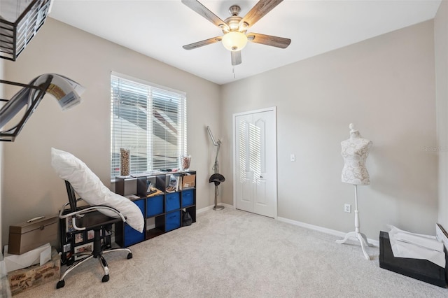 office space with ceiling fan and light carpet