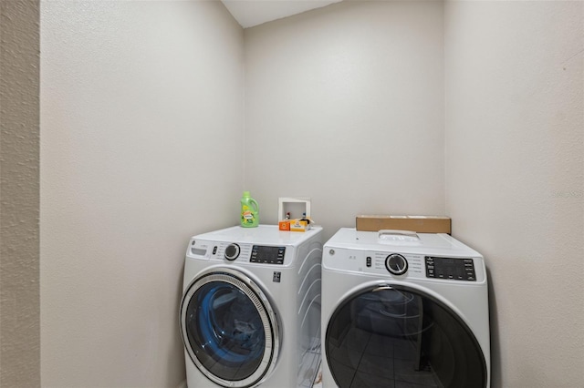 clothes washing area with separate washer and dryer